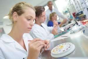 Female technician working in a dentures laboratory